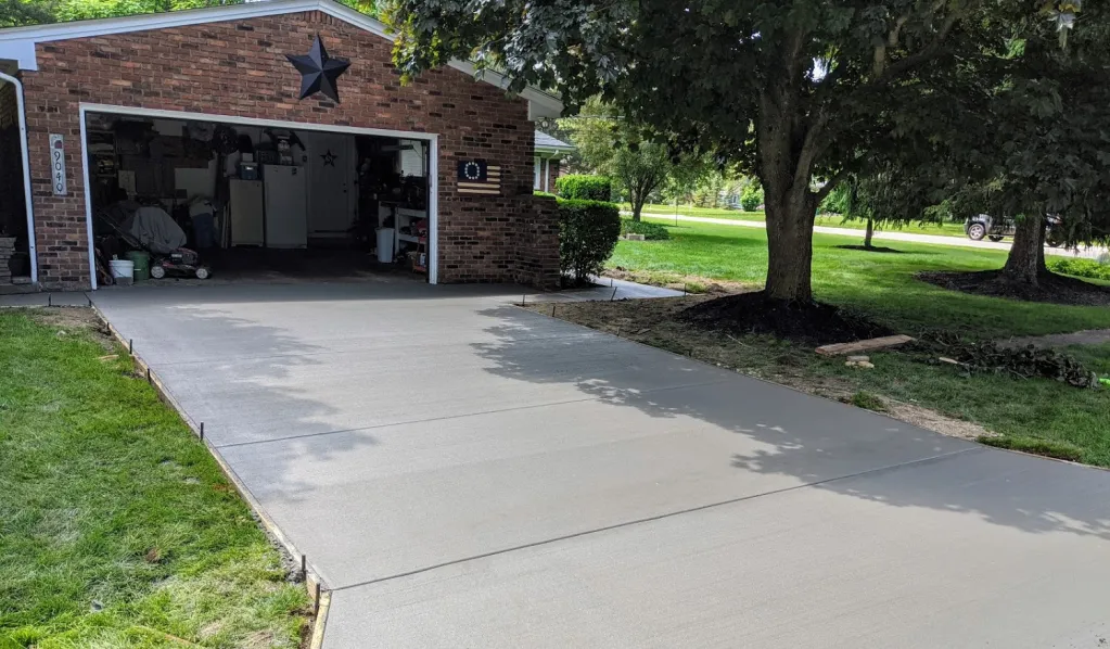 Xpress Construction & Services shows quality work with a new driveway and garage, making the home look neat and inviting.
