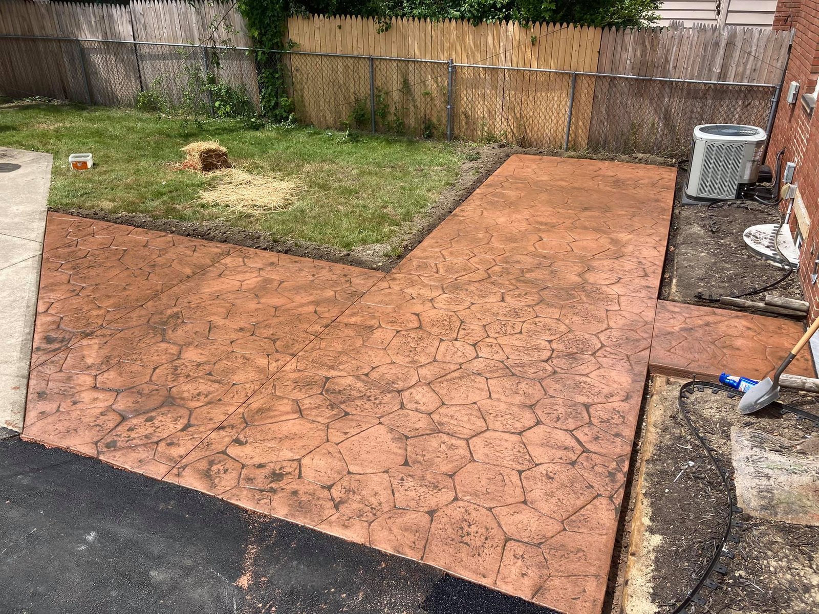 Xpress Construction & Services shows a new walkway and patio, highlighting skilled concrete work that makes the yard look neat and inviting.