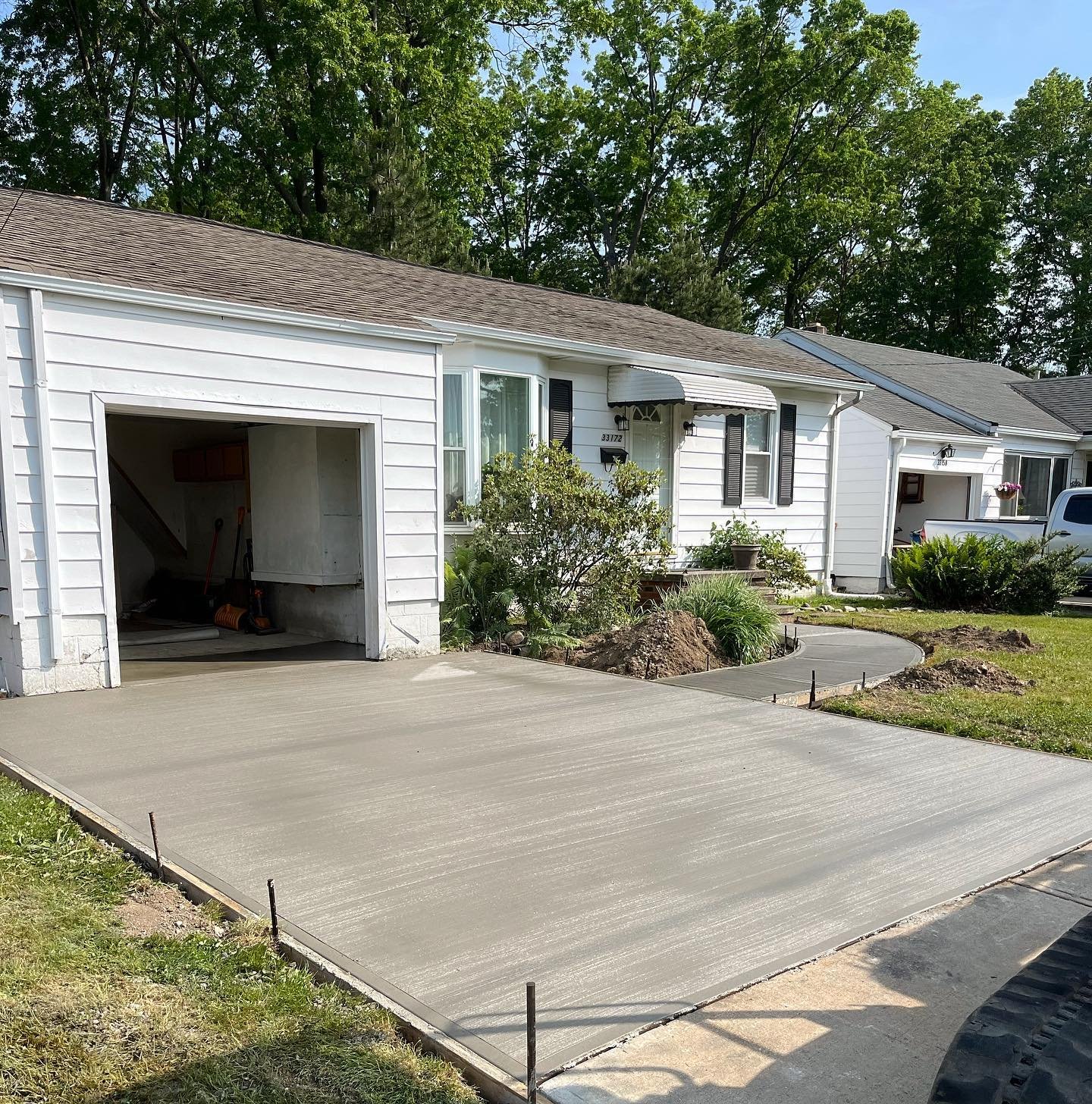 Xpress Construction & Services shows a new concrete driveway for a single-story home, ready for use and curb appeal.