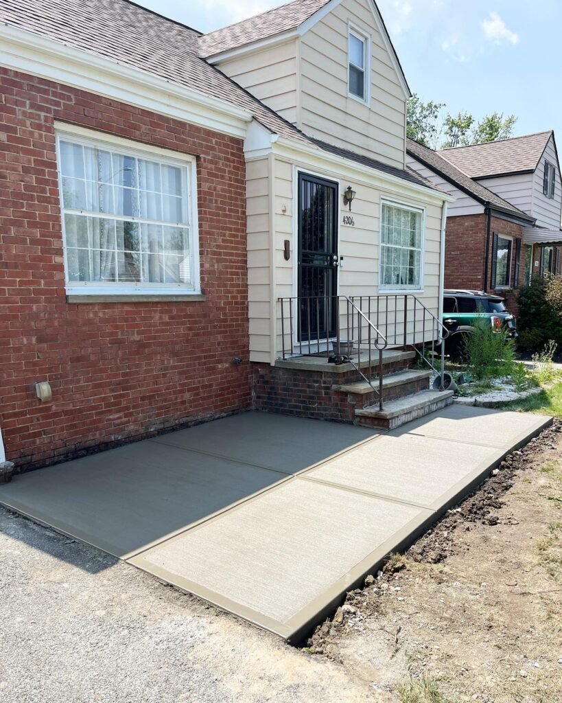 Xpress Construction & Services shows a newly done sidewalk with quality concrete work leading up to a tidy front entry.