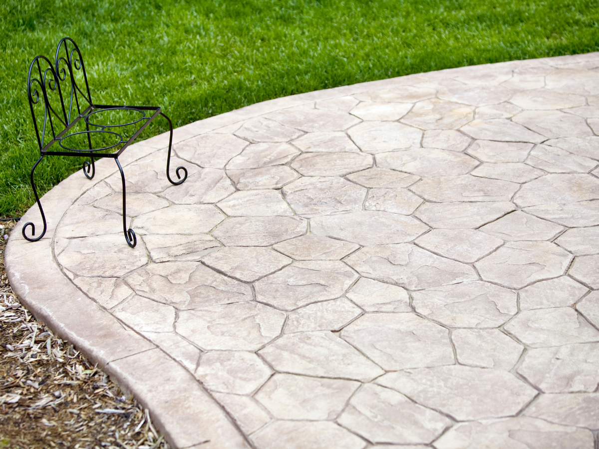 Xpress Construction & Services delivers a welcoming outdoor patio with quality concrete work and neat landscaping.